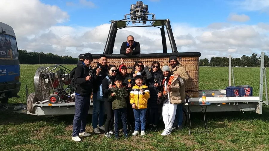 Passengers celebrating after a hot air balloon flight over Methven Canterbury