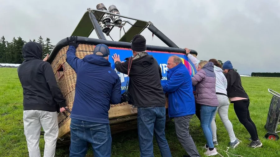Crew manoeuvring hot air balloon basket before attaching in Methven Canterbury