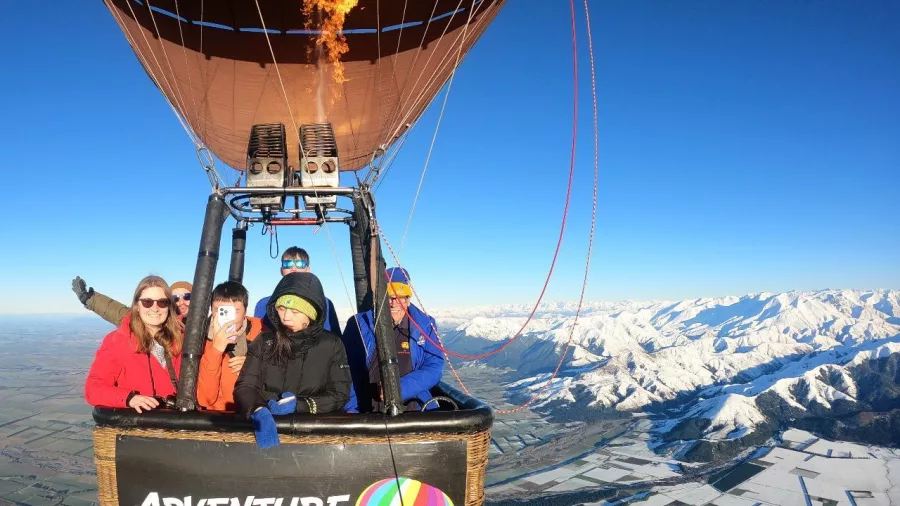 Adventure Balloons NZ passengers enjoying a scenic flight over Canterbury Plains and Southern Alps