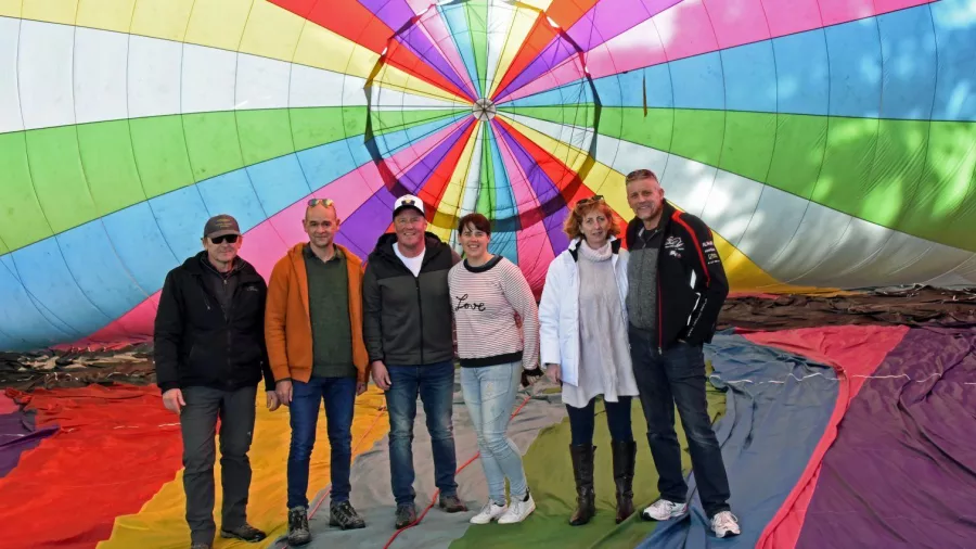 Group standing inside colourful hot air balloon envelope in Methven Canterbury