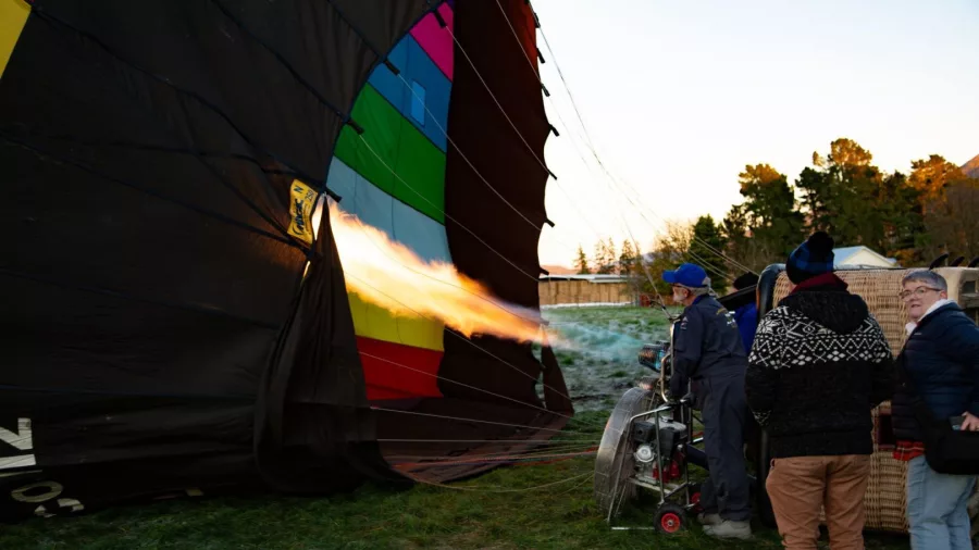 Crew using burner to inflate hot air balloon envelope in Methven Canterbury