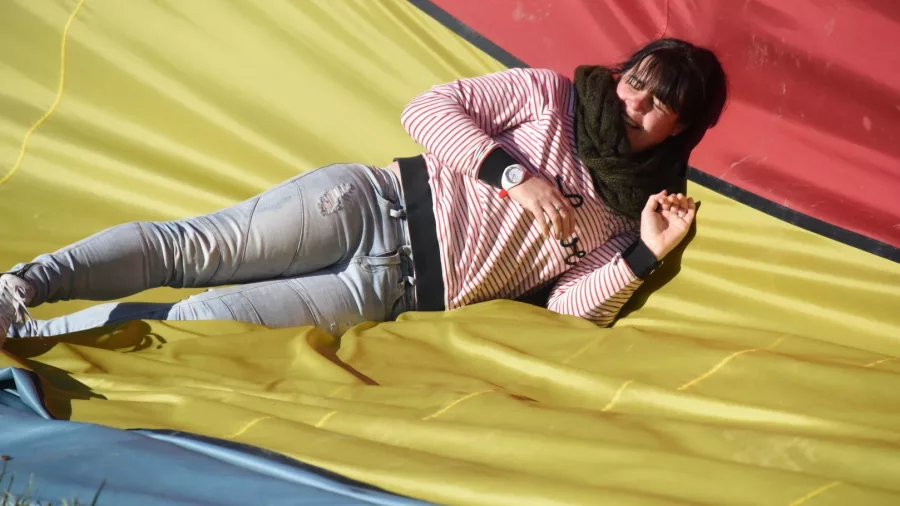 Woman lying on deflated hot air balloon envelope in Methven Canterbury