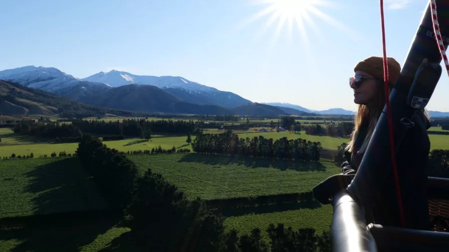 Woman enjoying scenic views from hot air balloon in Methven Canterbury