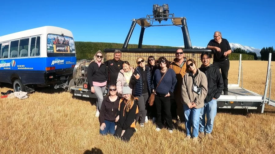 Hot air balloon passengers posing after landing in Methven Canterbury