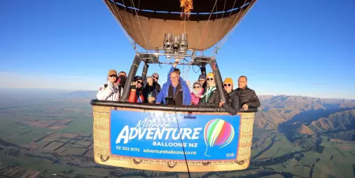 Adventure Balloons NZ hot air balloon flying over Canterbury Plains with Southern Alps backdrop