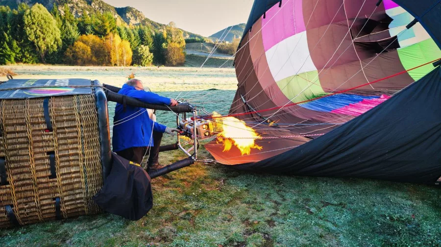 Pilot using burner to fill hot air balloon in Wanaka