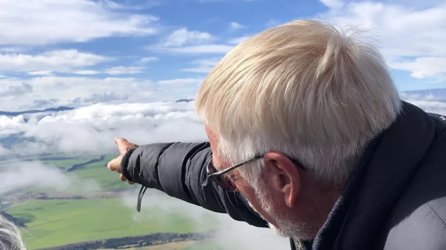 Passenger pointing out landmarks during Wanaka hot air balloon ride