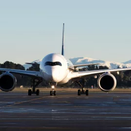 Airbus A350 on runway at Christchurch Airport with Southern Alps backdrop