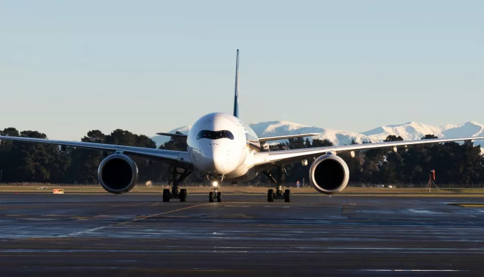 Airbus A350 on runway at Christchurch Airport with Southern Alps backdrop