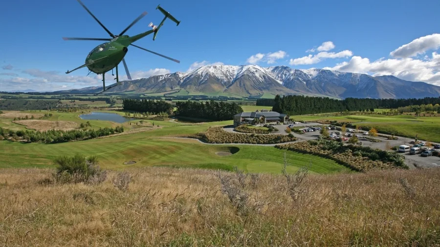 Helicopter arriving at Terrace Downs Golf Resort with mountain views