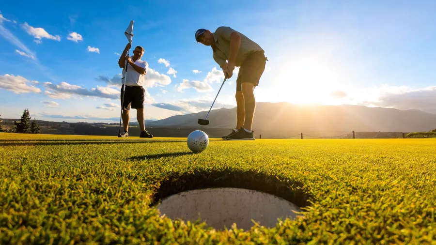 Golfer putting on the green at Terrace Downs Golf Resort in Canterbury high country