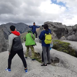 Tour group exploring the elevated limestone formations of Castle Hill on a guided excursion