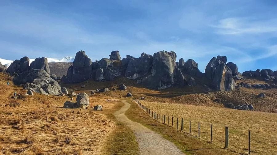 Gravel path leading towards the dramatic boulder formations at Castle Hill, New Zealand