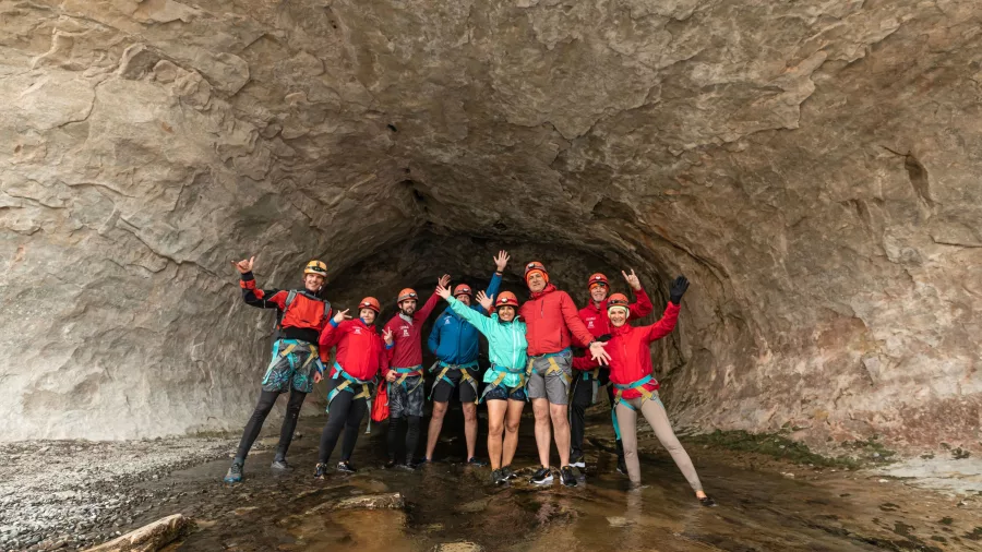 Group of cavers celebrating at the entrance of Cave Stream in Canterbury