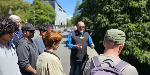Māori guide leading cultural walking tour near the Bridge of Remembrance in Christchurch