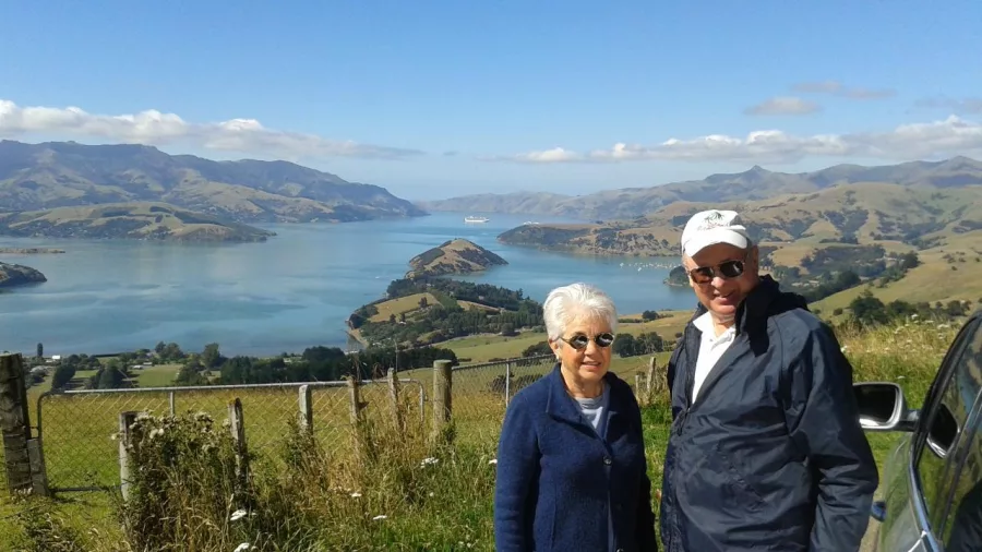 Elderly couple enjoying scenic views over Akaroa Harbour from a lookout on Banks Peninsula