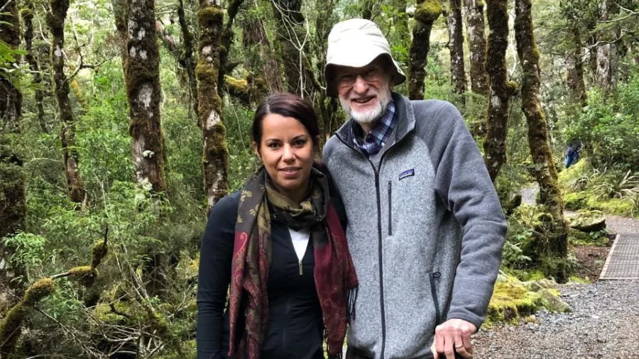 Forest walk in Arthur’s Pass with tour guide and elderly visitor on gravel track