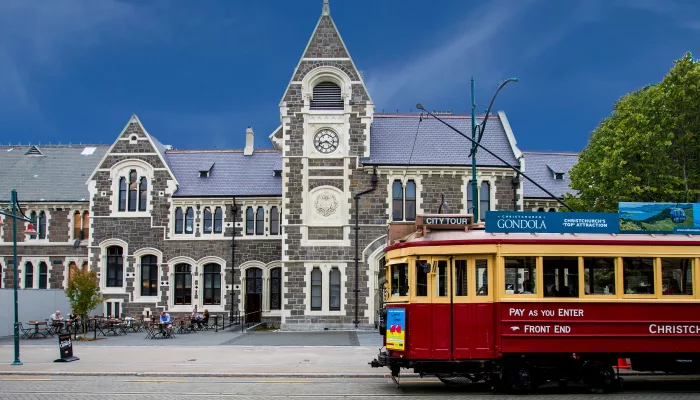 Historic red Christchurch tram outside the Arts Centre building