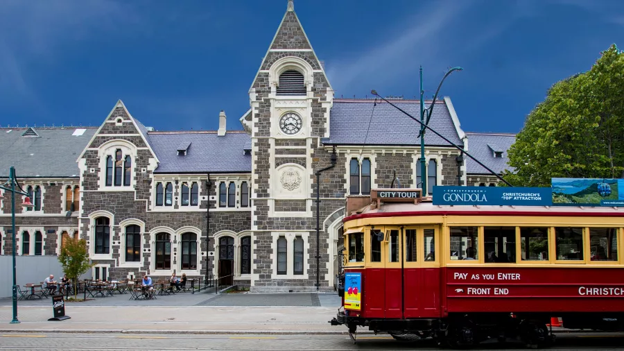 Historic red Christchurch tram outside the Arts Centre building