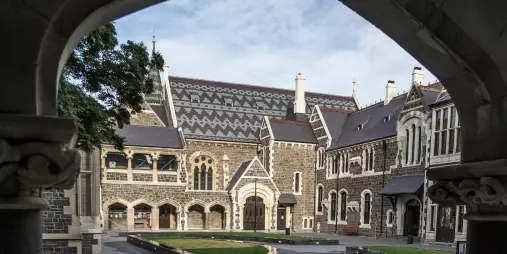 Gothic Revival buildings of the Christchurch Arts Centre seen through a stone arch