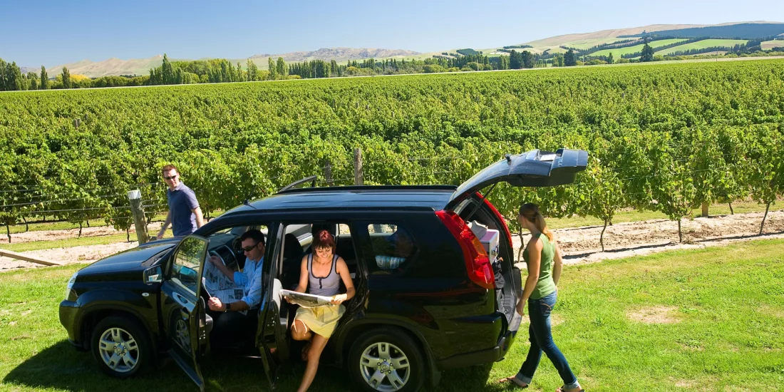 Friends arriving by car for a wine tasting in the Hurunui region near Waipara.