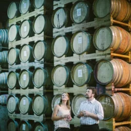 Visitors exploring the impressive barrel hall at Pegasus Bay Winery in Waipara Valley.