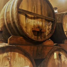 Wooden wine barrels storing Main Divide Te Hau Reserve Pinot Noir at Pegasus Bay.