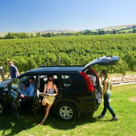 Friends arriving by car for a wine tasting in the Hurunui region near Waipara.