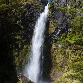 Devil's Punchbowl Waterfall cascading down a rocky cliff in Arthur's Pass National Park