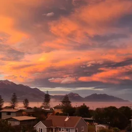 Fiery sunset sky over the coastal town of Kaikōura with the Seaward Kaikōura Ranges in the background