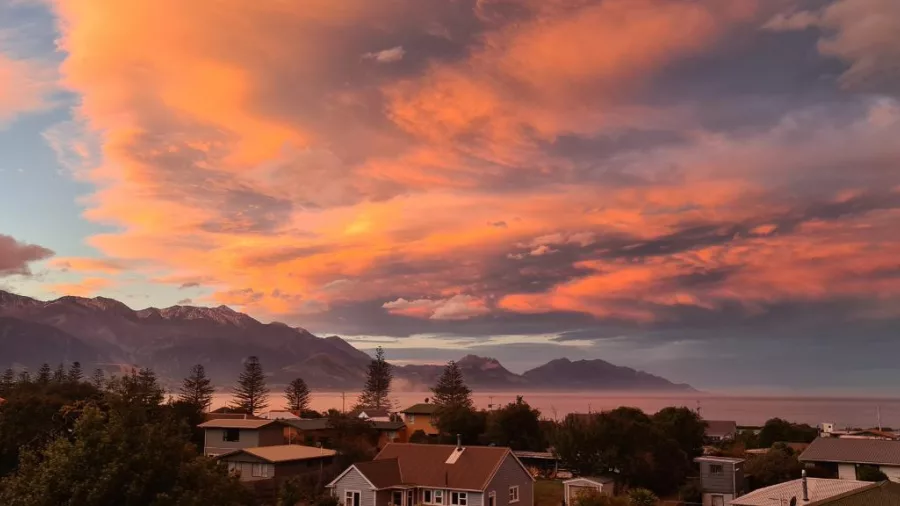 Fiery sunset sky over the coastal town of Kaikōura with the Seaward Kaikōura Ranges in the background
