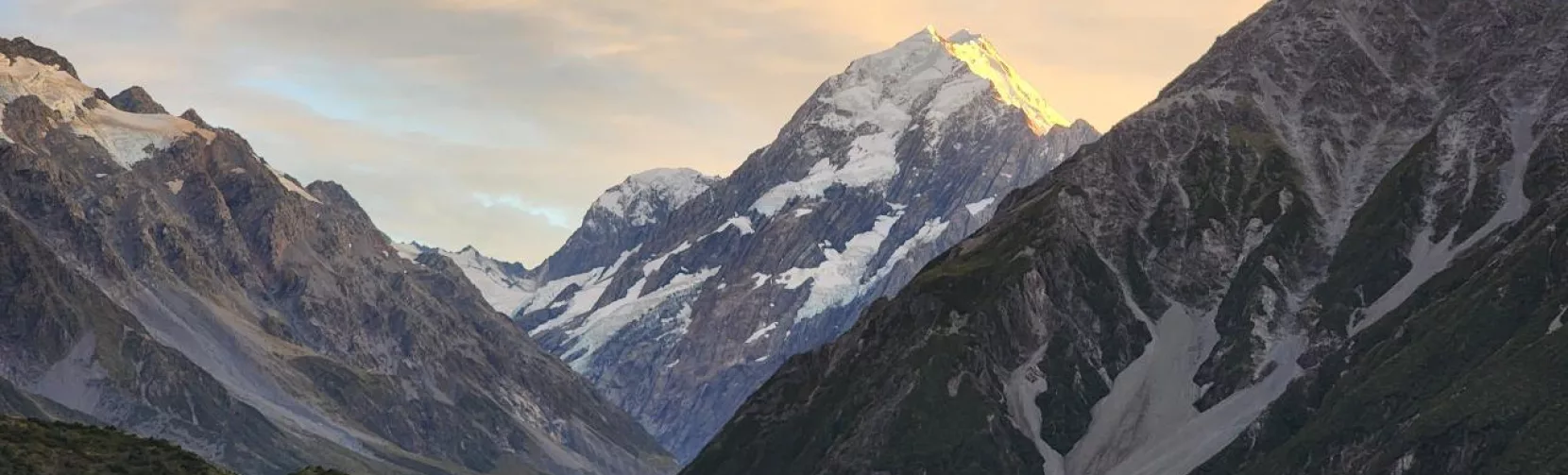 Sunset lighting up Aoraki Mount Cook with golden tones over the surrounding valley