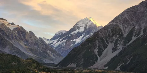Sunset lighting up Aoraki Mount Cook with golden tones over the surrounding valley