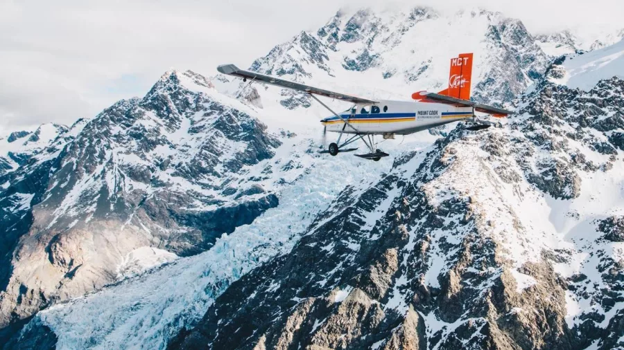 Scenic flight plane flying over a snowy glacier in Aoraki Mount Cook National Park