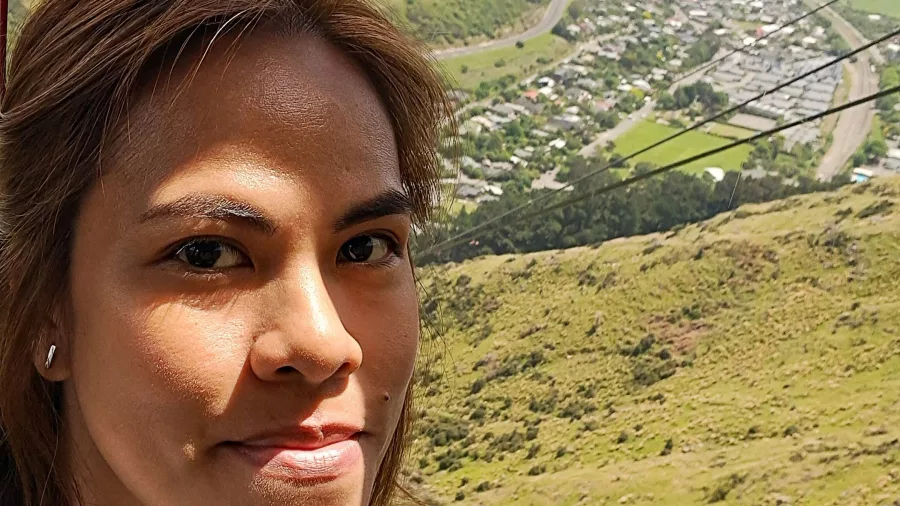Jen taking a selfie inside Christchurch Gondola cabin with city view behind