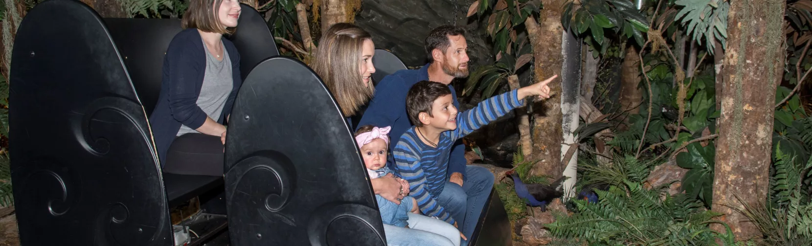 Family on a ride through native forest scenery in the Christchurch Gondola’s Time Tunnel