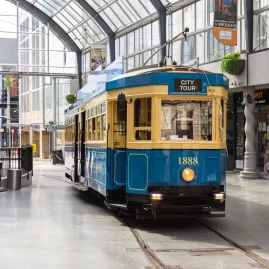 Christchurch tram passing through the glass-roofed Cathedral Junction arcade.