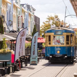 Christchurch tram travelling along colourful New Regent Street with alfresco dining.