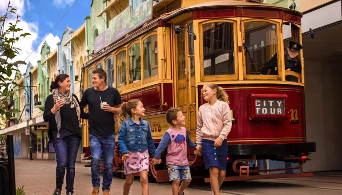 Family walking beside a Christchurch Tram on New Regent Street