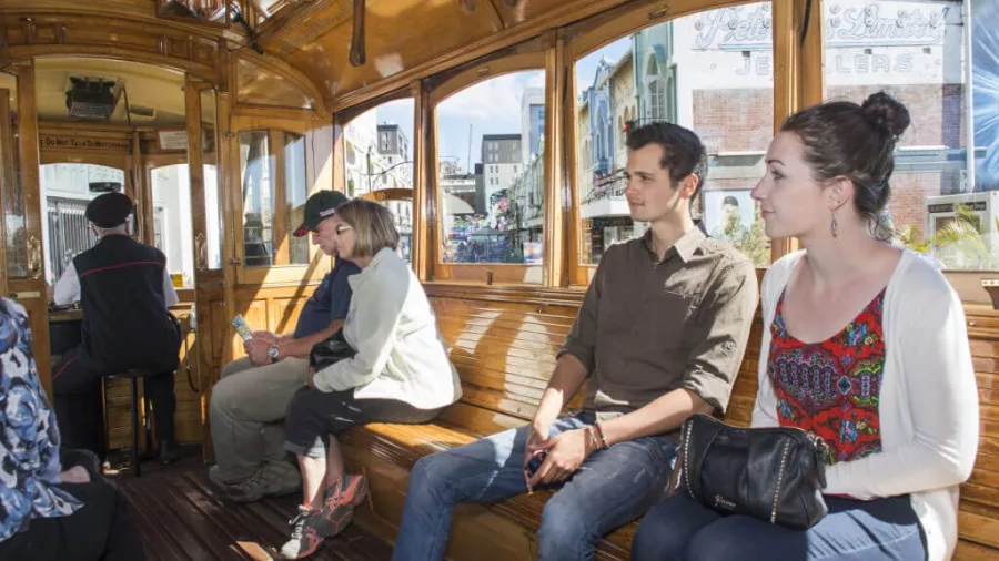 Passengers seated inside the Christchurch Tram with views of New Regent Street through the windows