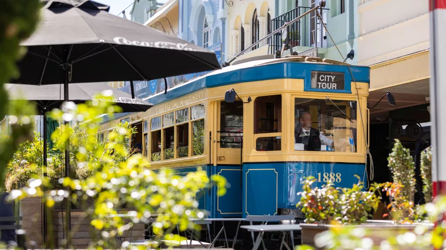 Historic New Regent Street in Christchurch with pastel-coloured Spanish Mission architecture and the Christchurch Tram