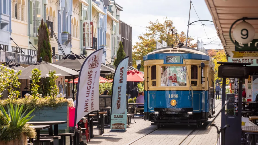 Christchurch tram travelling along colourful New Regent Street with alfresco dining.