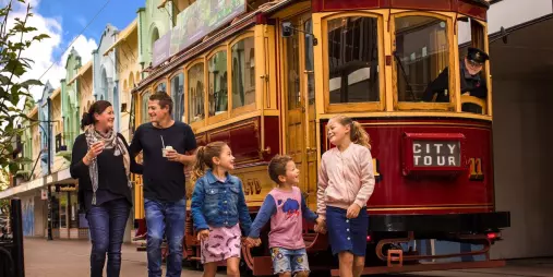 Family walking beside a Christchurch Tram on New Regent Street
