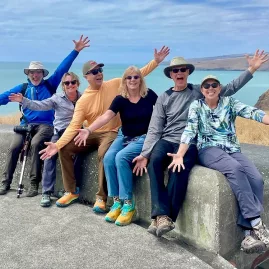 Walkers sitting atop an old WWII coastal defence structure at Godley Head