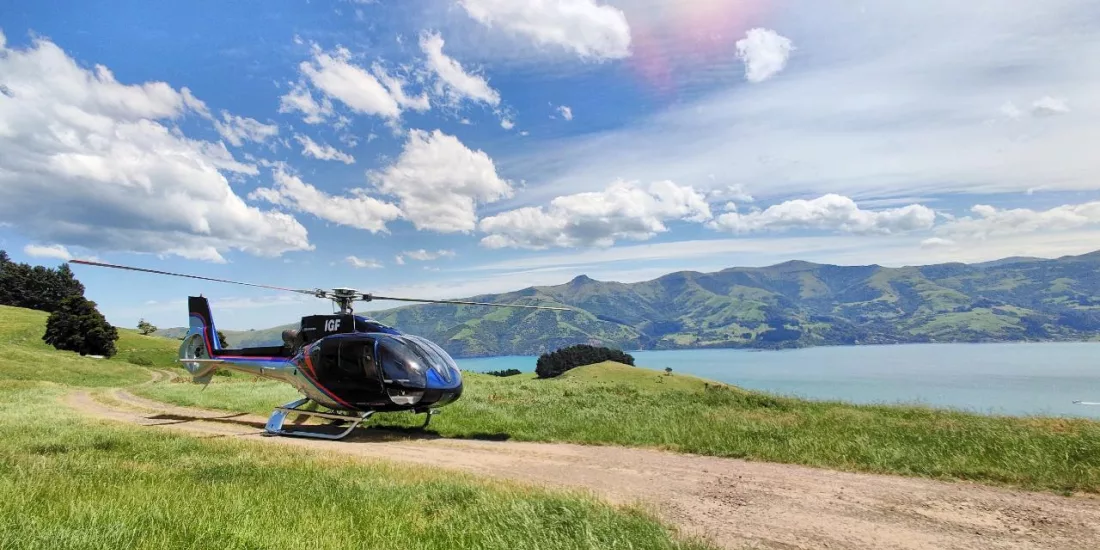 Scenic helicopter parked with panoramic view of Akaroa Harbour