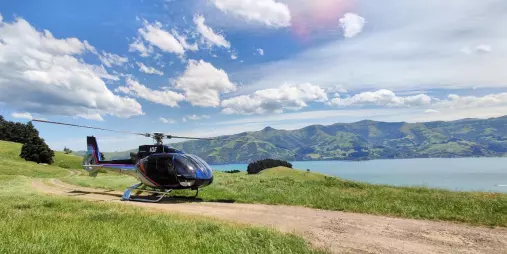 Scenic helicopter parked with panoramic view of Akaroa Harbour