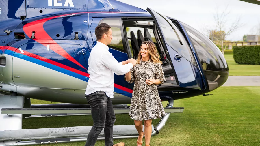 Couple stepping out of helicopter at winery in North Canterbury for a luxury lunch experience