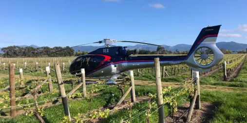 Helicopter nestled among the vines at Black Estate Winery in North Canterbury