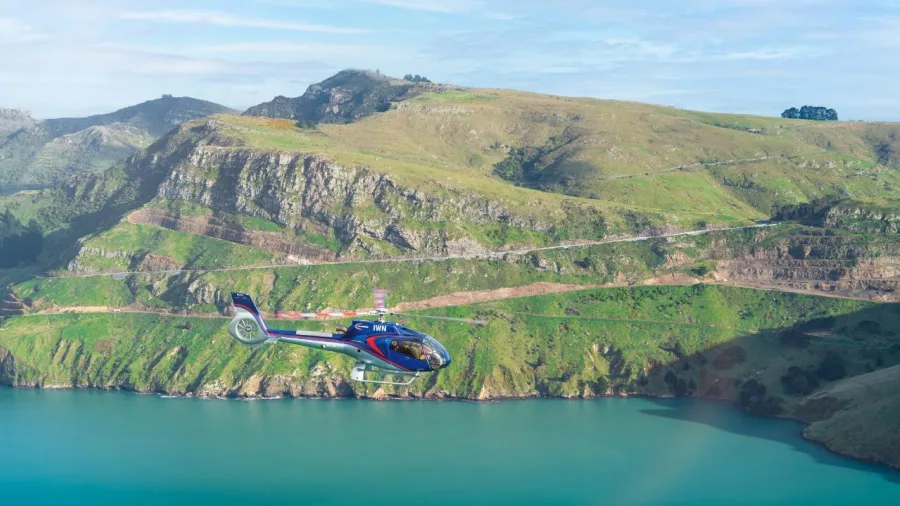 Helicopter flying past Port Hills above Christchurch coast