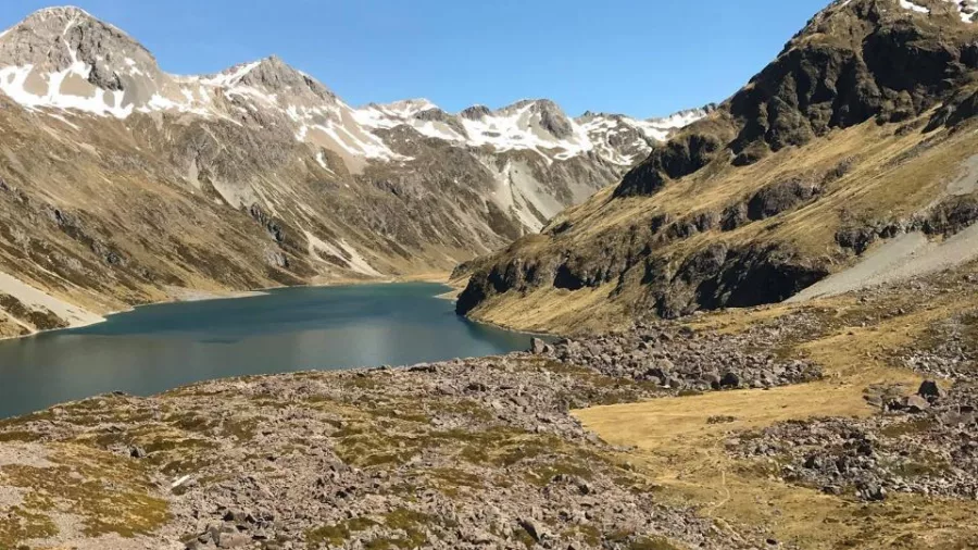 Remote alpine landing area nestled among rocky peaks on Southern Alps Explorer helicopter flight